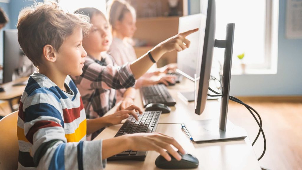 Alunos tendo aula a partir  do plano de aula usando a tecnologia na educação infantil